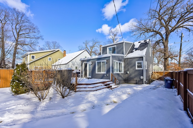 snow covered property featuring fence