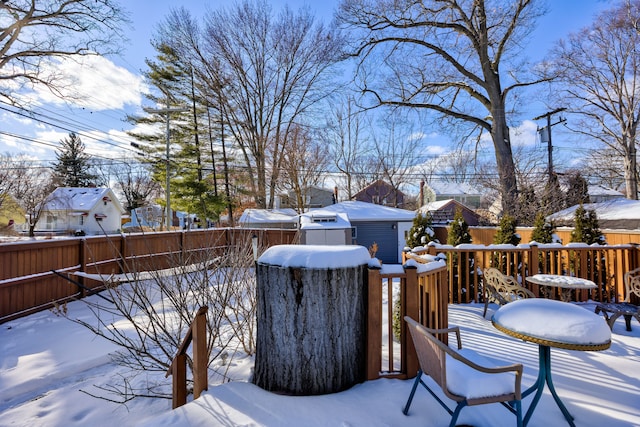 snow covered deck featuring a residential view