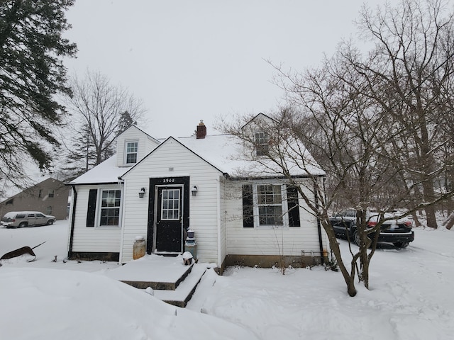 view of front facade featuring a garage and a chimney