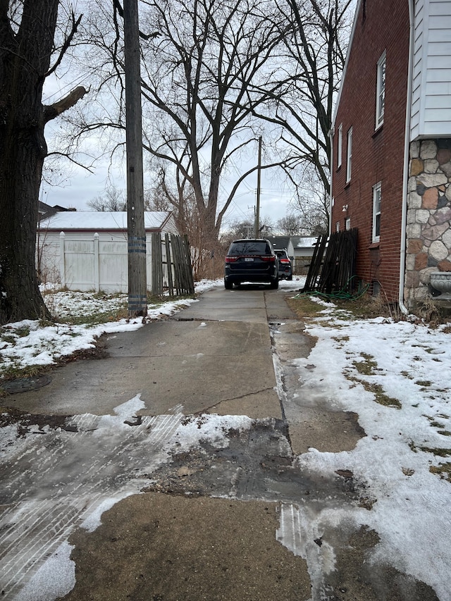 yard layered in snow with driveway