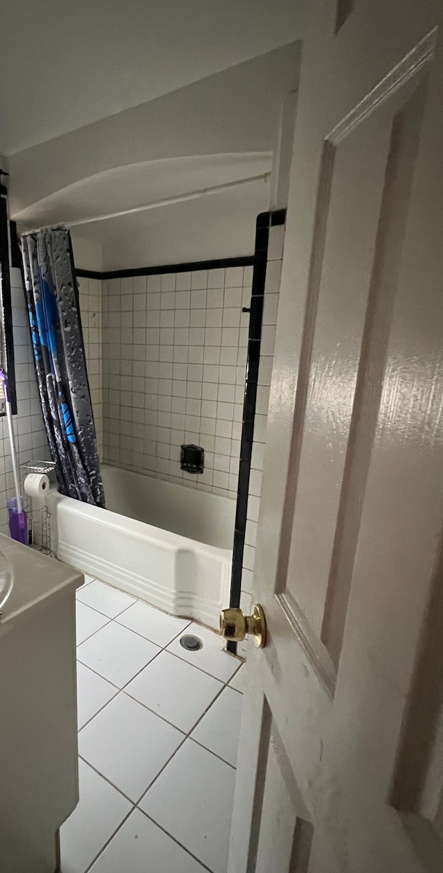 bathroom featuring shower / bath combo with shower curtain, vanity, and tile patterned floors