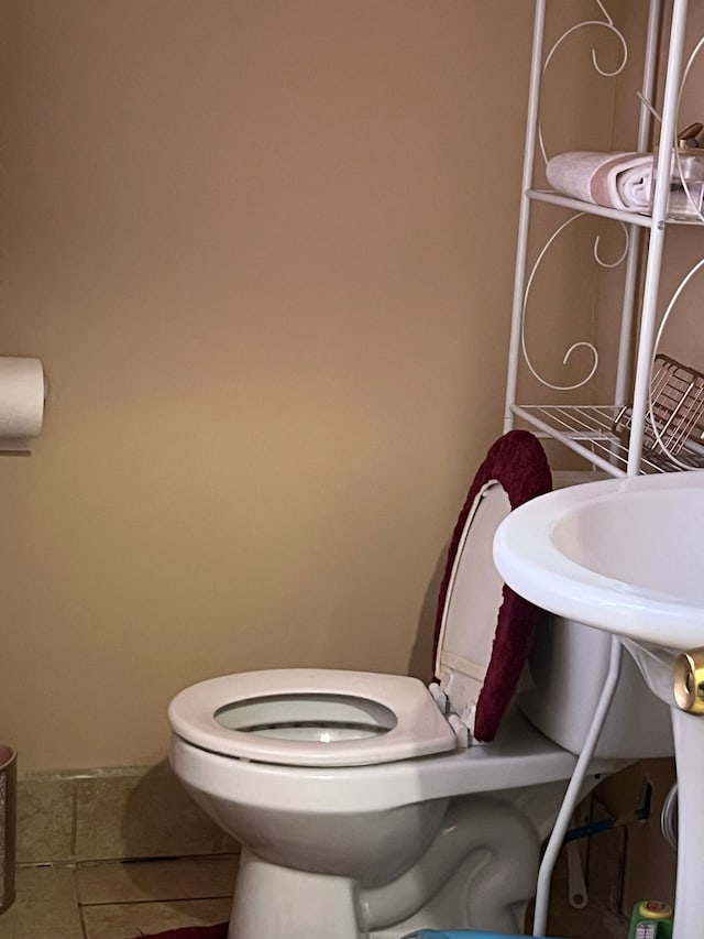 bathroom with toilet and tile patterned floors