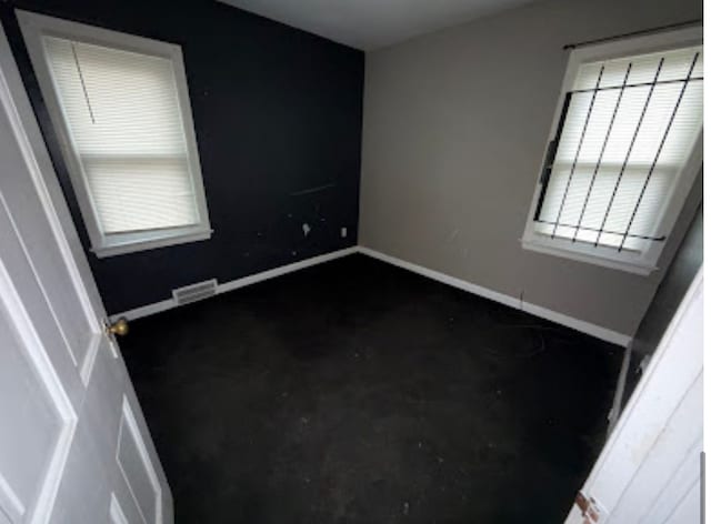 spare room with visible vents and baseboards