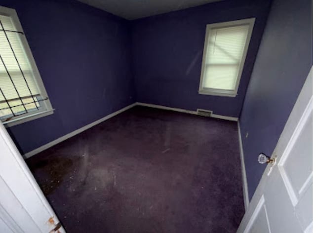 empty room with visible vents and baseboards