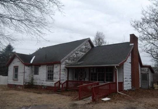 rear view of property featuring a chimney