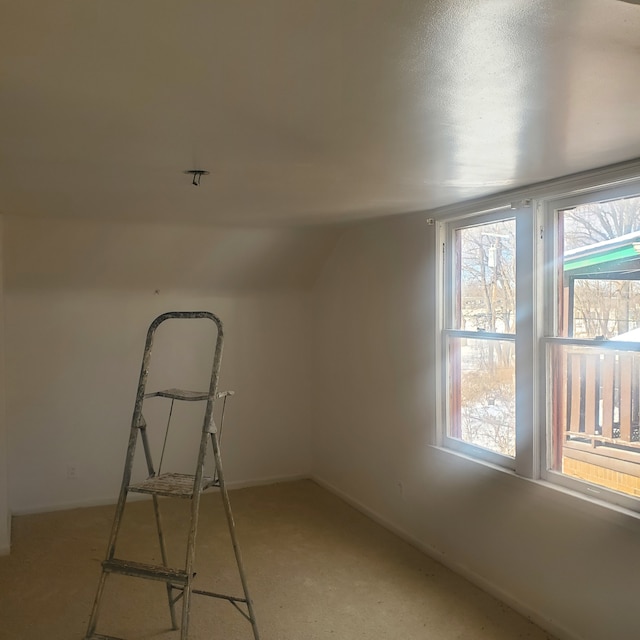 unfurnished room with lofted ceiling