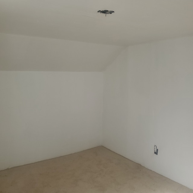 bonus room featuring lofted ceiling and light carpet