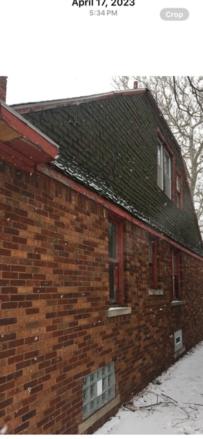 view of side of property featuring brick siding