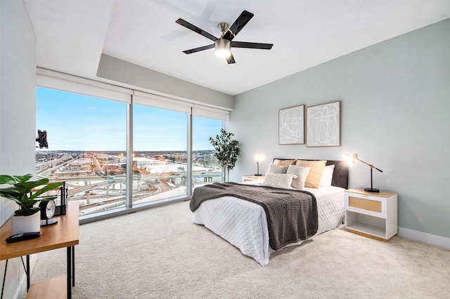 bedroom with access to exterior, baseboards, a ceiling fan, and light colored carpet