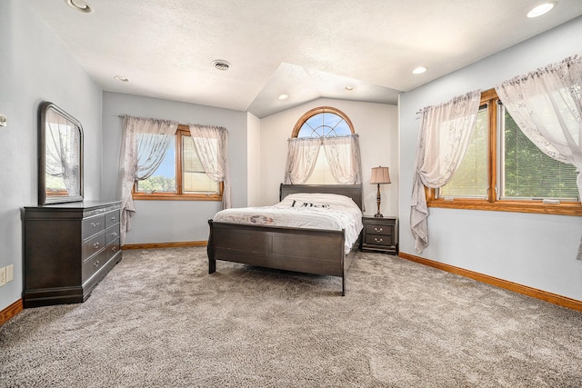 carpeted bedroom featuring baseboards, multiple windows, and visible vents