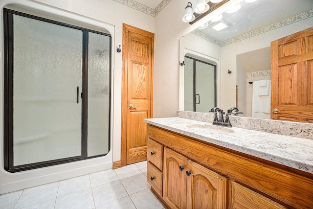 full bath featuring a stall shower, vanity, and tile patterned floors