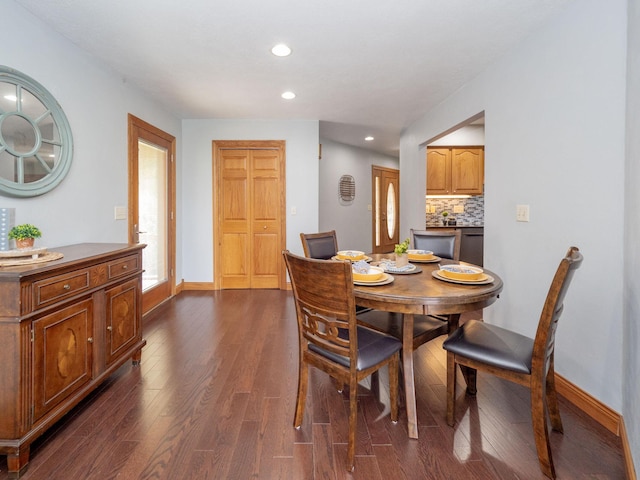 dining room with dark wood-style floors, recessed lighting, and baseboards