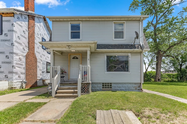 view of front of home featuring a shingled roof and a front lawn