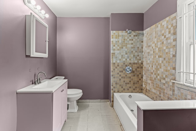 full bathroom with a washtub, toilet, vanity, baseboards, and tile patterned floors