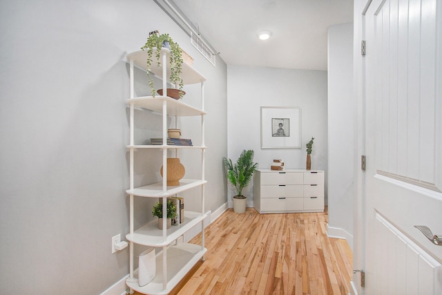 hall with wood finished floors and baseboards