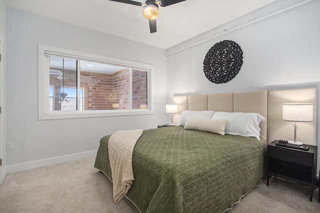 carpeted bedroom featuring baseboards and a ceiling fan