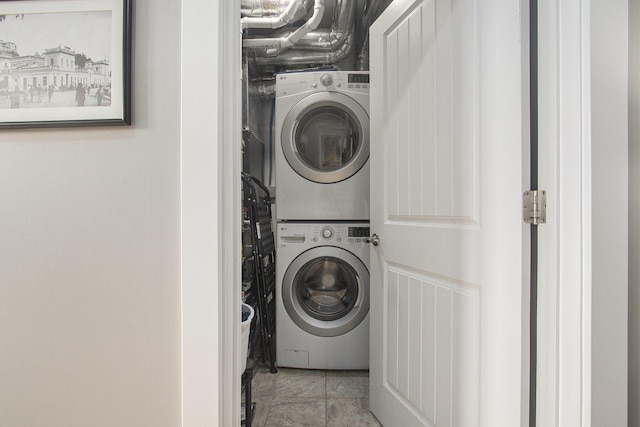 laundry area featuring stacked washer / dryer and laundry area