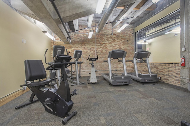 exercise room with brick wall