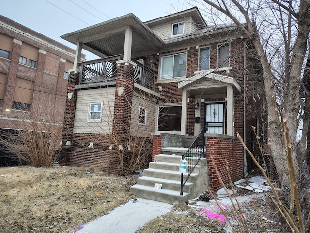 american foursquare style home with brick siding