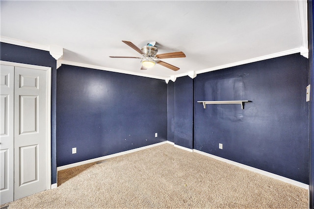 unfurnished bedroom with visible vents, baseboards, ceiling fan, crown molding, and carpet flooring