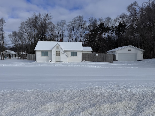 view of front of house with a garage, a chimney, and an outbuilding