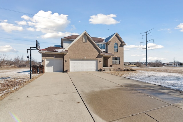 traditional-style house featuring brick siding, driveway, and a garage