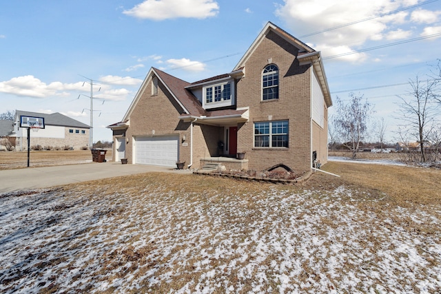 traditional-style house with brick siding, an attached garage, and driveway