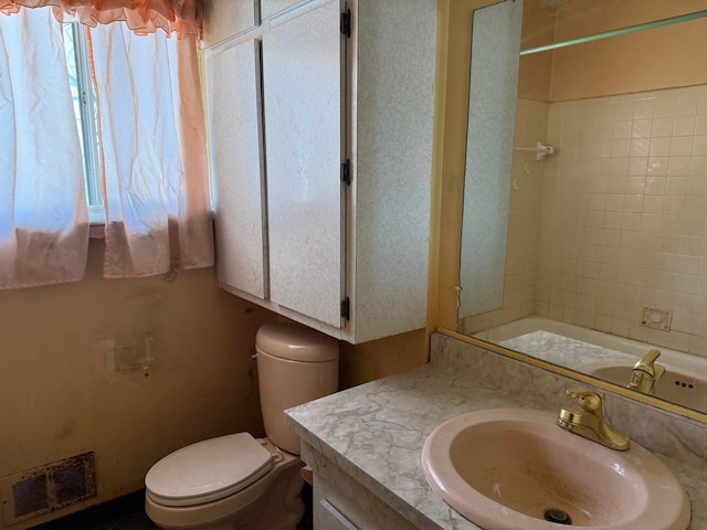 bathroom featuring visible vents, vanity, toilet, and walk in shower