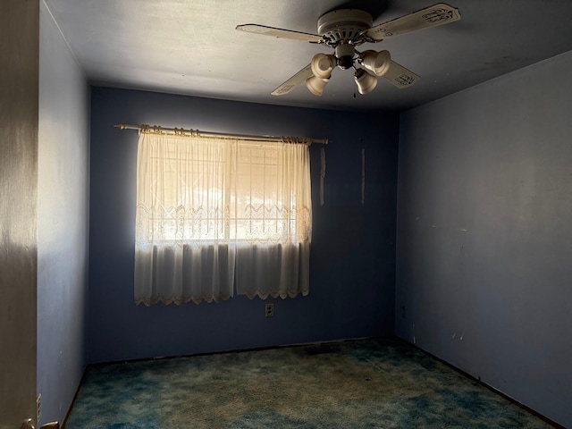 empty room featuring a ceiling fan and carpet flooring