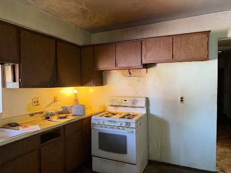 kitchen with light countertops and white gas range