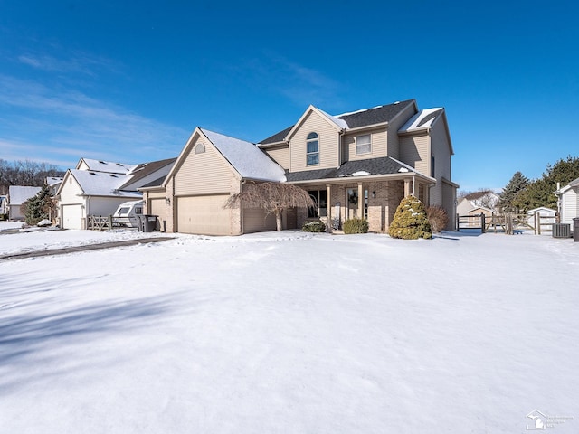 traditional-style house with a residential view, brick siding, fence, and an attached garage