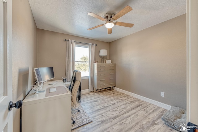 office featuring a textured ceiling, light wood finished floors, and baseboards