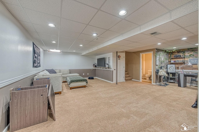 living room with carpet, recessed lighting, visible vents, a drop ceiling, and stairs