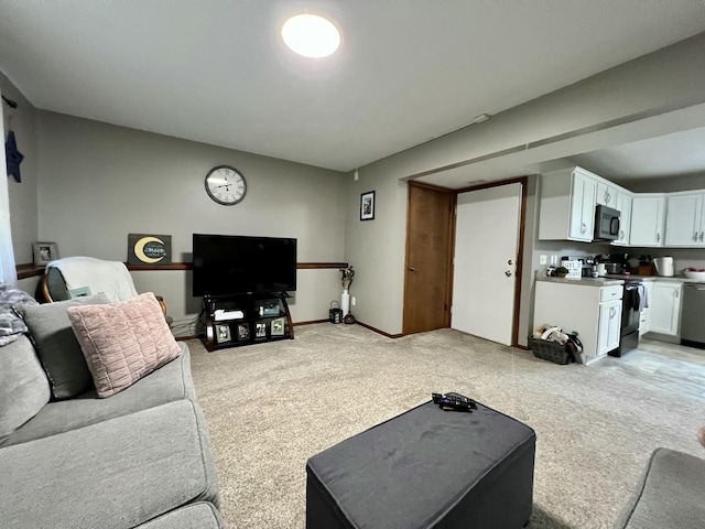 living area featuring light carpet and baseboards