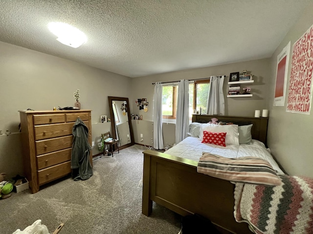 bedroom featuring light carpet and a textured ceiling