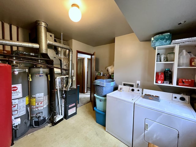 washroom featuring water heater, laundry area, and independent washer and dryer