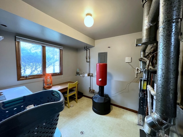 home office with light floors, electric panel, and baseboards