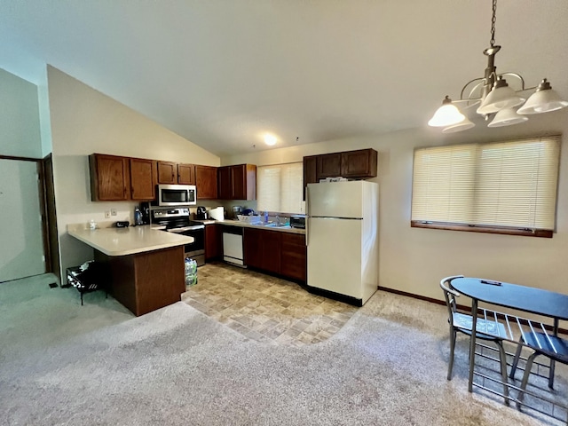 kitchen featuring pendant lighting, light countertops, appliances with stainless steel finishes, light carpet, and a peninsula