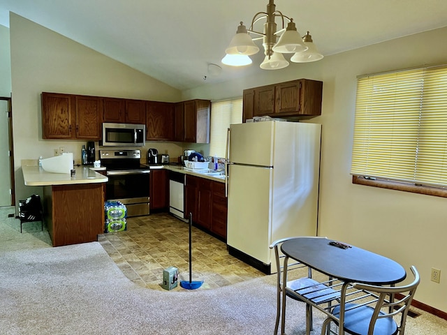 kitchen with stainless steel appliances, light countertops, hanging light fixtures, light carpet, and vaulted ceiling