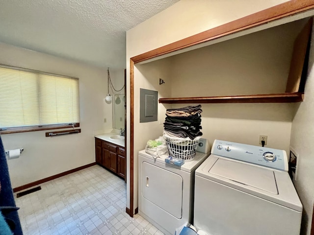 clothes washing area with electric panel, a textured ceiling, visible vents, and washer and dryer