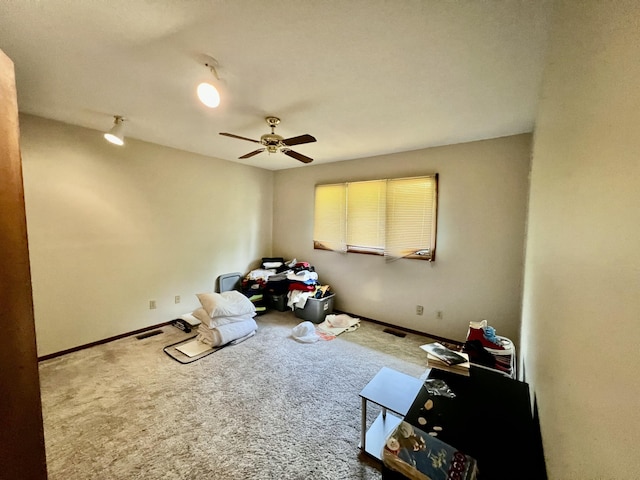 unfurnished bedroom with a ceiling fan, carpet flooring, visible vents, and baseboards