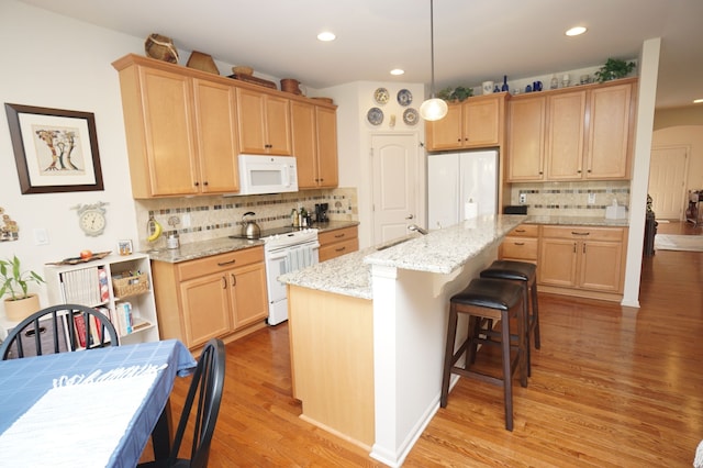 kitchen featuring decorative backsplash, light brown cabinetry, arched walkways, light wood finished floors, and white appliances