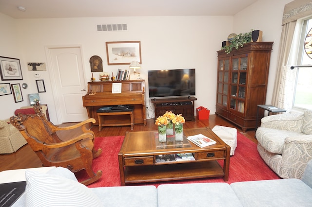 living room with visible vents, plenty of natural light, and wood finished floors