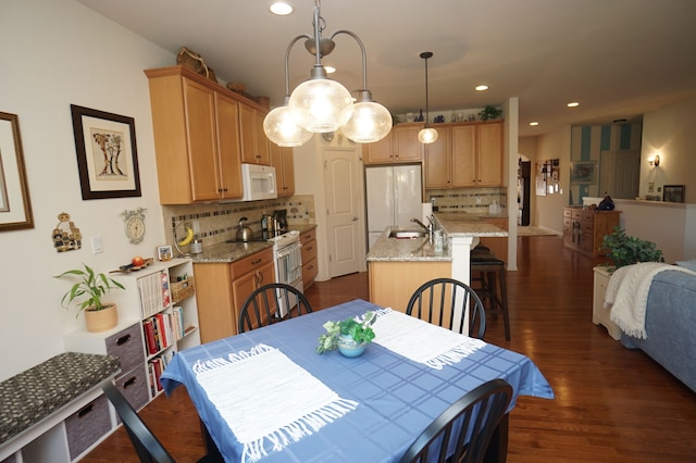 dining room with recessed lighting and dark wood-type flooring