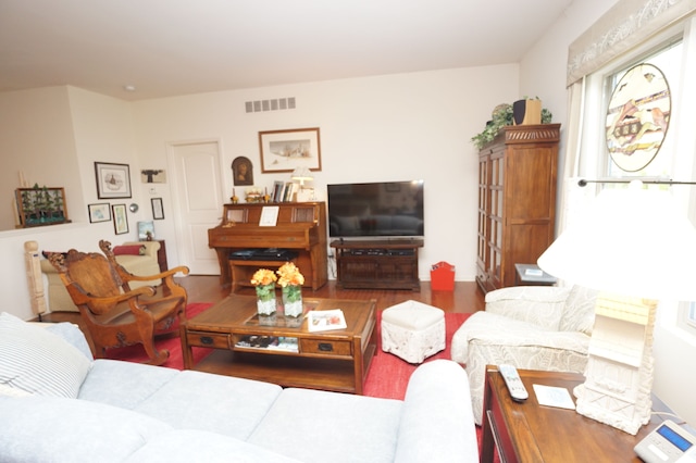 living room with wood finished floors and visible vents