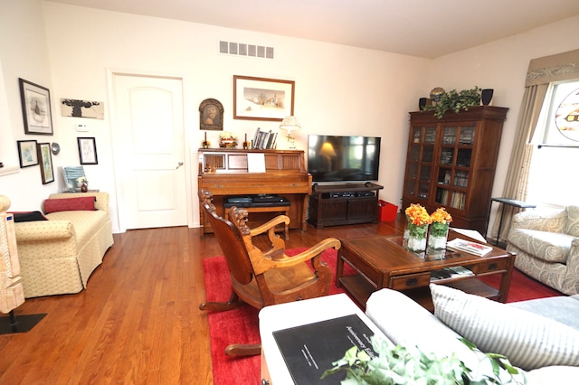 living area featuring wood finished floors and visible vents