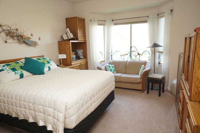 bedroom featuring light carpet