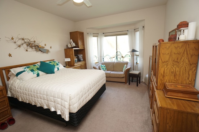bedroom with a ceiling fan and light colored carpet