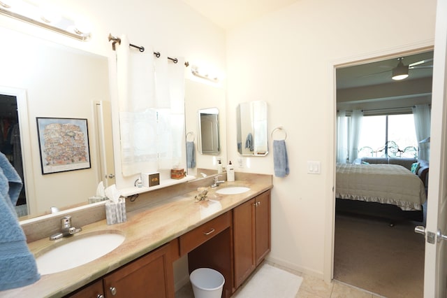 bathroom with tile patterned flooring, a sink, and connected bathroom