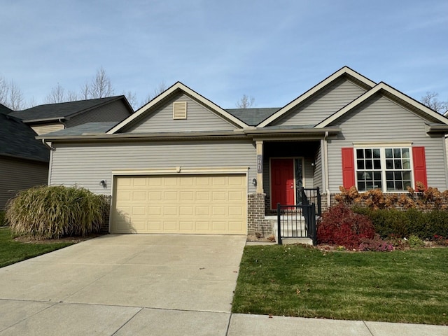 view of front of home with an attached garage, driveway, and a front lawn